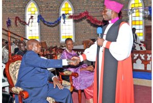Rt. Rev. Nathan Ahimbisibwe, the South Ankole Diocese bishop, prays for President Museveni and wife Janet at St. Matthew Cathedral in Kyamate during the Easter service yesterday. Other clerics have asked the President not to stand again for presidency come 2016. photo by PPU